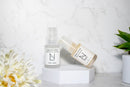 Elodie's Naturals: Two serum pump bottles arranged at an angle